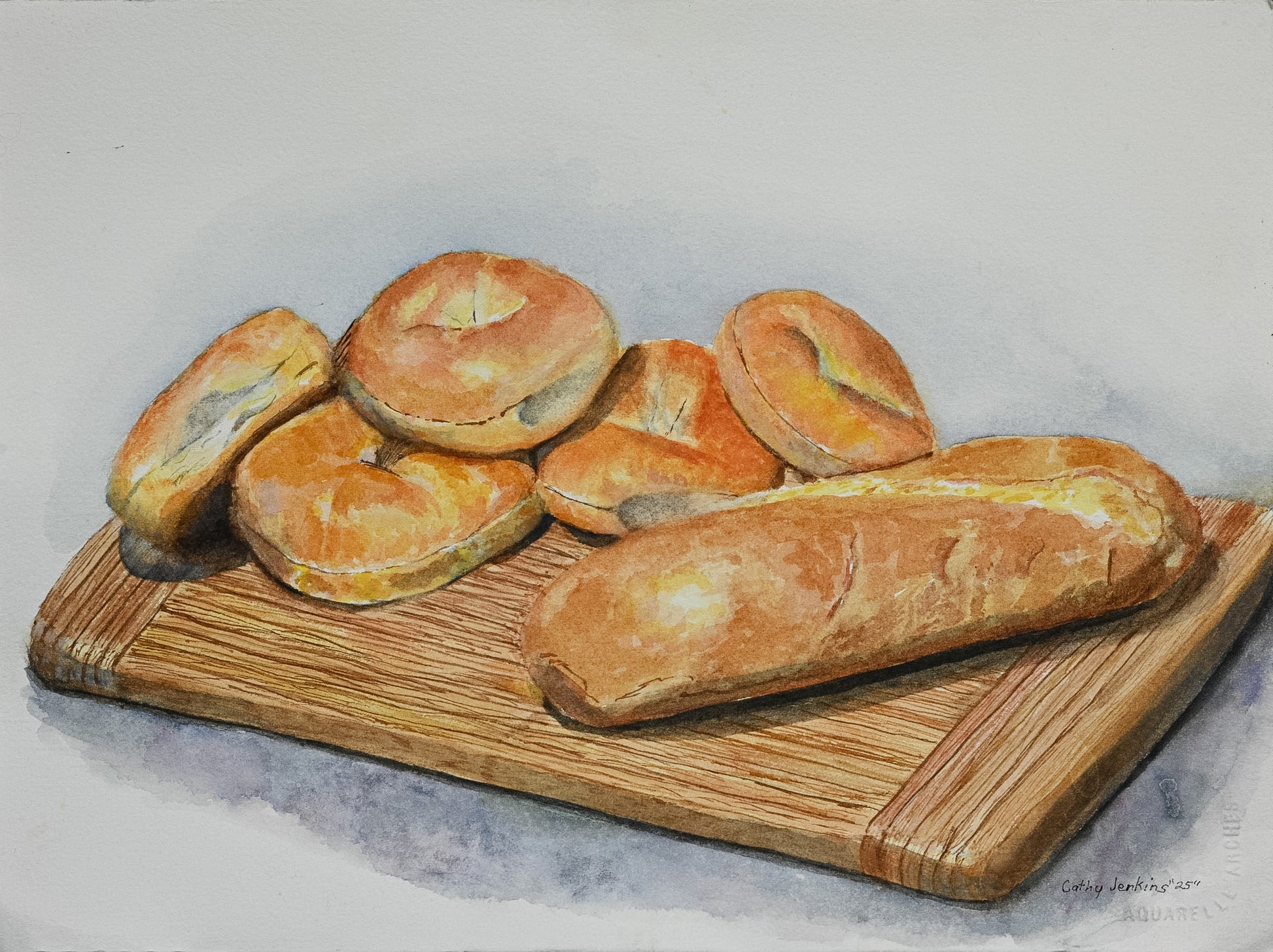 Original watercolor still life painting titled Fresh Baked Bread and Bagels by Cathy Jenkins featuring bread and bagels on a wooden cutting board.
